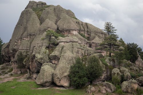 Free Dramatic rocky formation amidst lush greenery under a cloudy sky in Mexico. Stock Photo