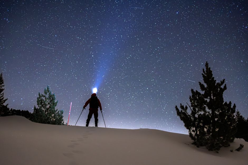 A nighttime skiing adventure with a starlit sky backdrop, capturing the essence of exploration and solitude.