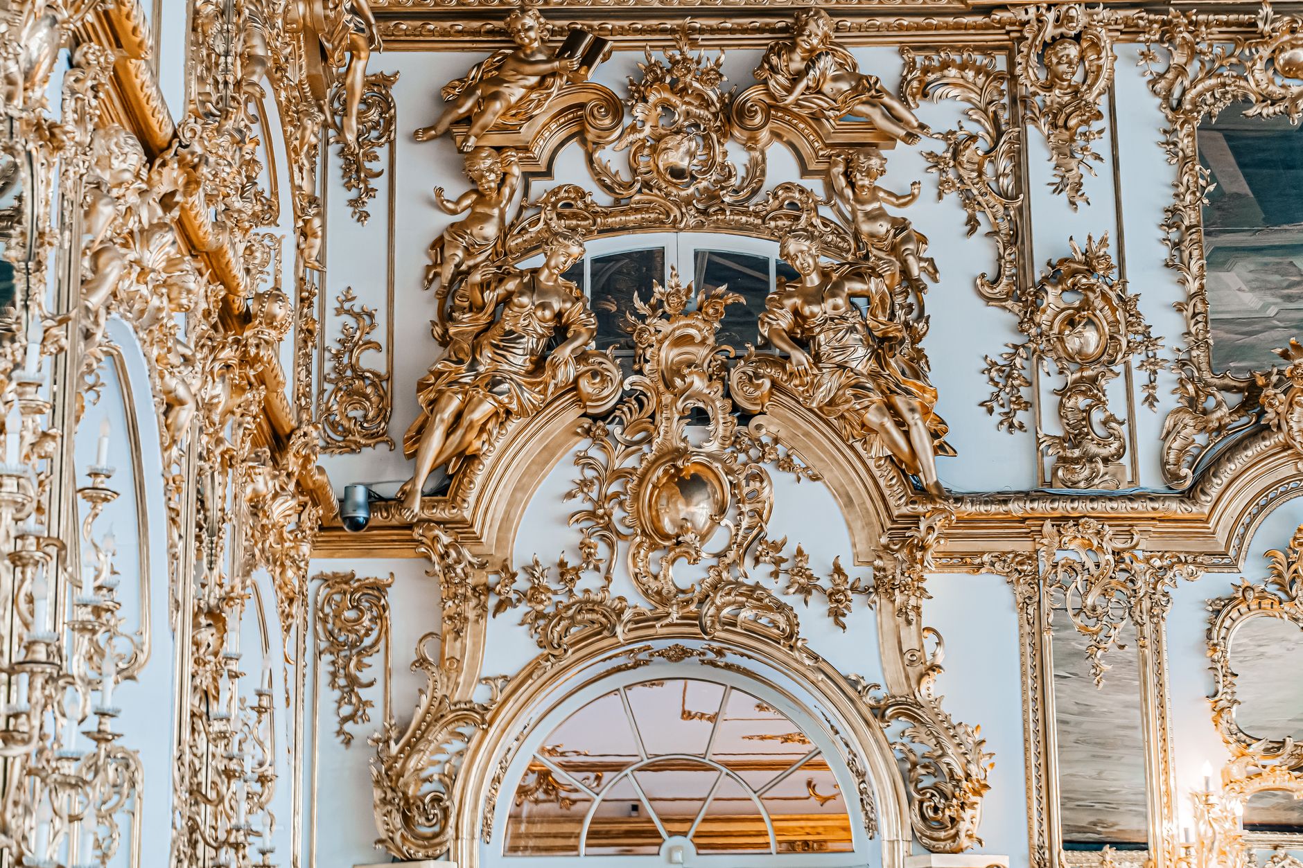 Luxurious gold decorations in a baroque palace interior showcasing intricate architectural details.