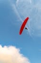 Paraglider Soaring High in Clear Blue Sky