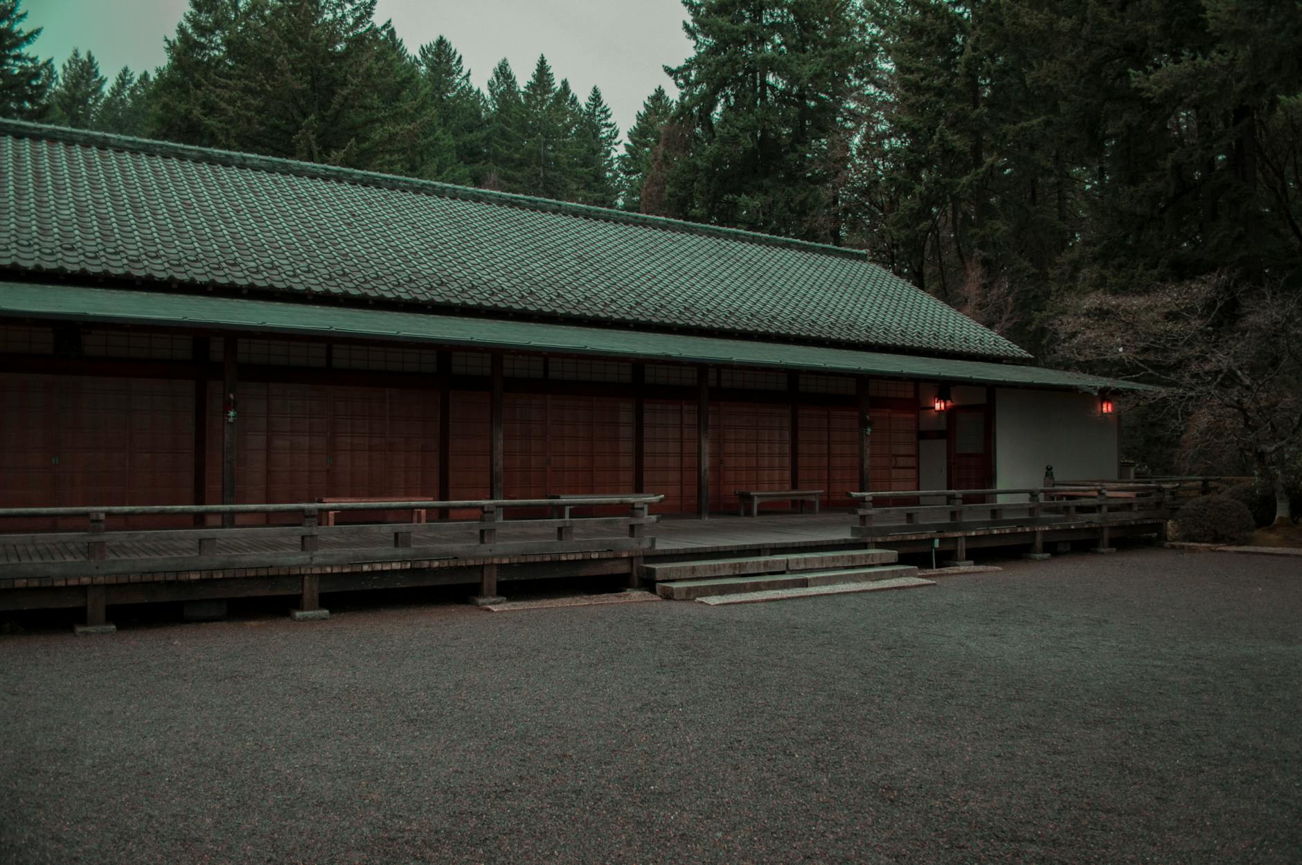 A peaceful Japanese-style building surrounded by lush trees in Portland, Oregon creates a serene atmosphere.