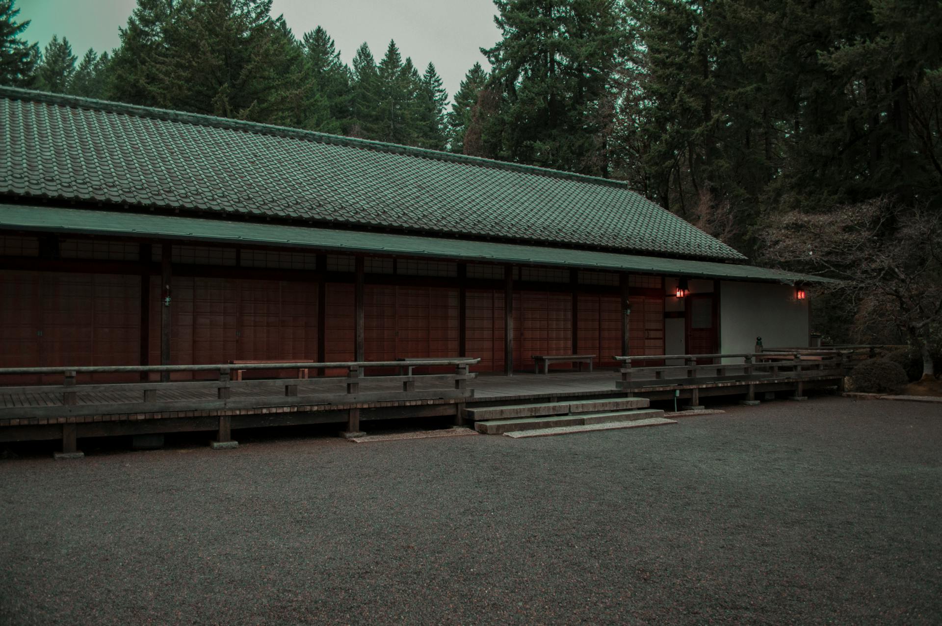 A peaceful Japanese-style building surrounded by lush trees in Portland, Oregon creates a serene atmosphere.