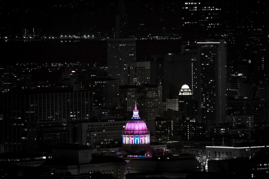 city landmark lit up purple at night