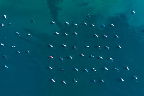 Free Aerial shot of boats moored on the serene, blue waters of Lake Tahoe, California. Stock Photo