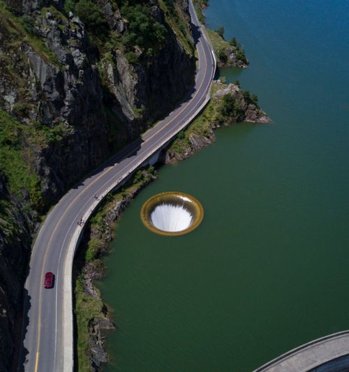 Free Stunning aerial shot of Lake Berryessa's Glory Hole Spillway with surrounding landscape and road. Stock Photo