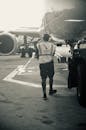 Airport Ground Crew Member Walking by Aircraft