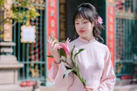 Elegant Woman Holding Lily in Traditional Dress