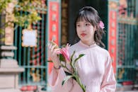 Young Woman in Traditional Vietnamese Dress with Flower