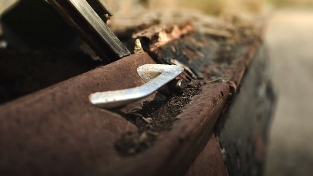 Rusted car with focus on vintage metallic details and texture.