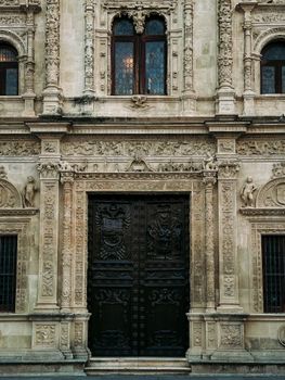 Detailed Renaissance architecture facade in Seville, showcasing intricate stone carvings and artistry.