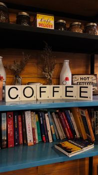 Wooden cafe bookshelf with coffee decor and books, perfect cozy ambiance