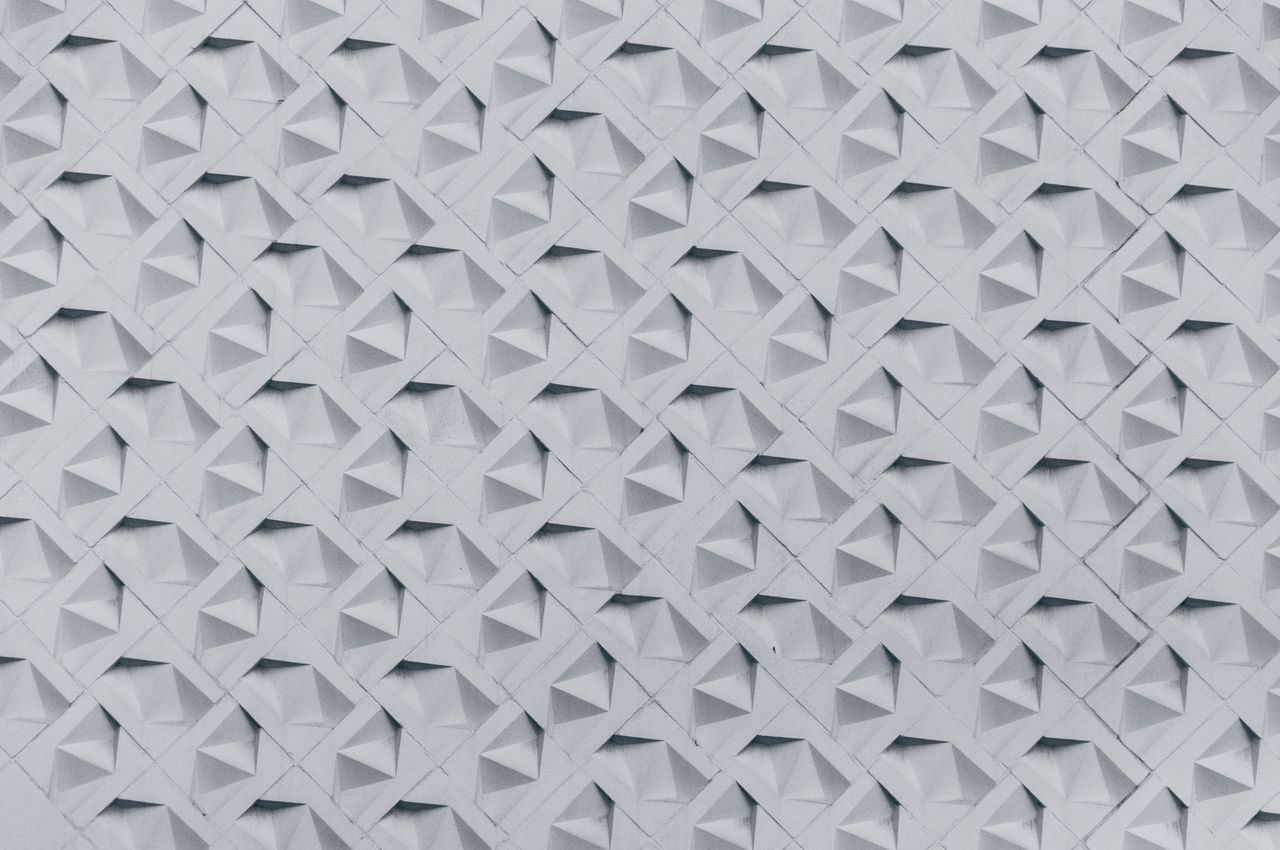 textured wall showcasing a geometric 3d pattern in monochrome tones pe