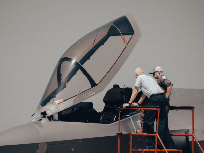 Crew inspecting a military aircraft cockpit