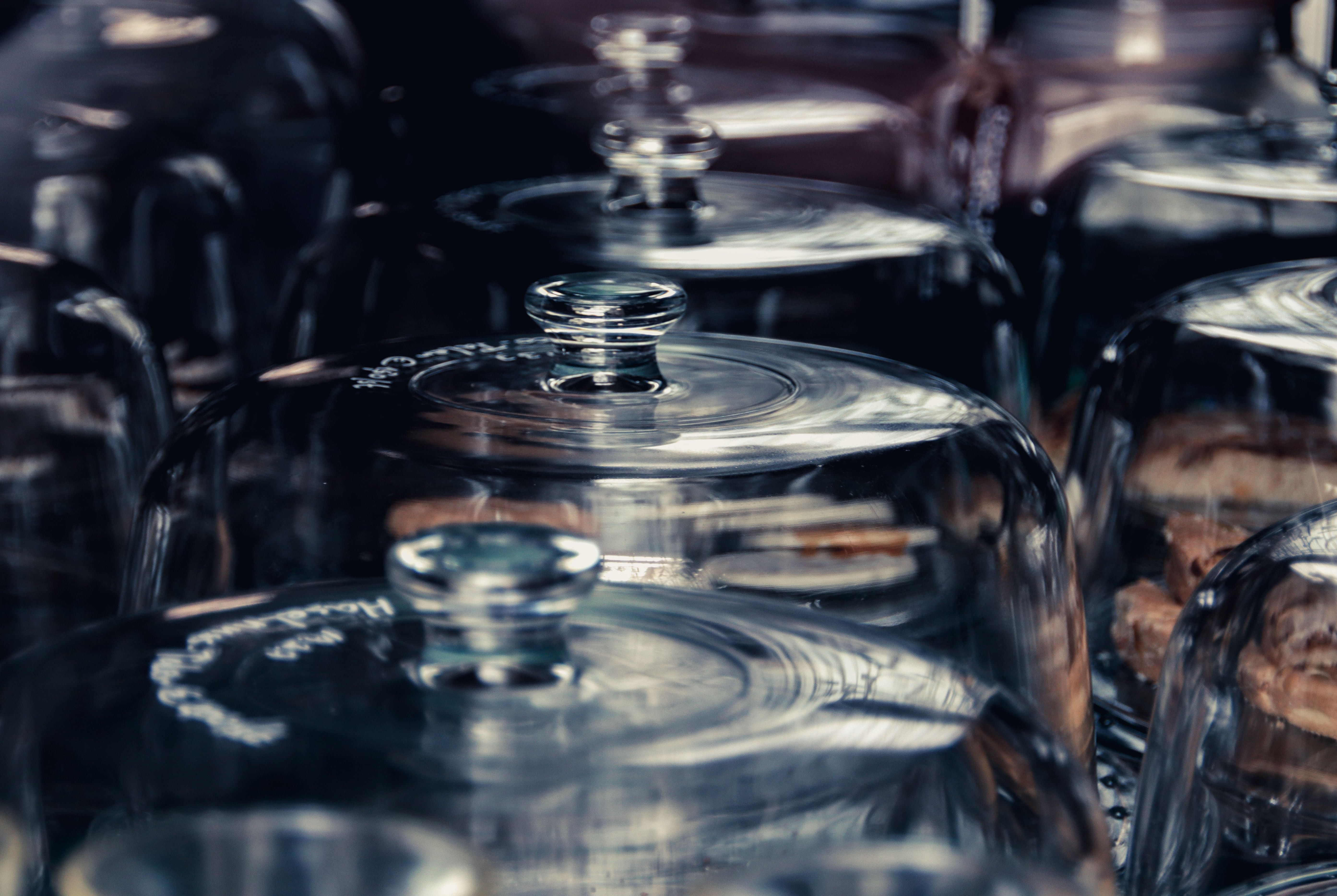 Elegant glass domes showcasing baked treats in a bakery. Perfect for culinary-themed designs.