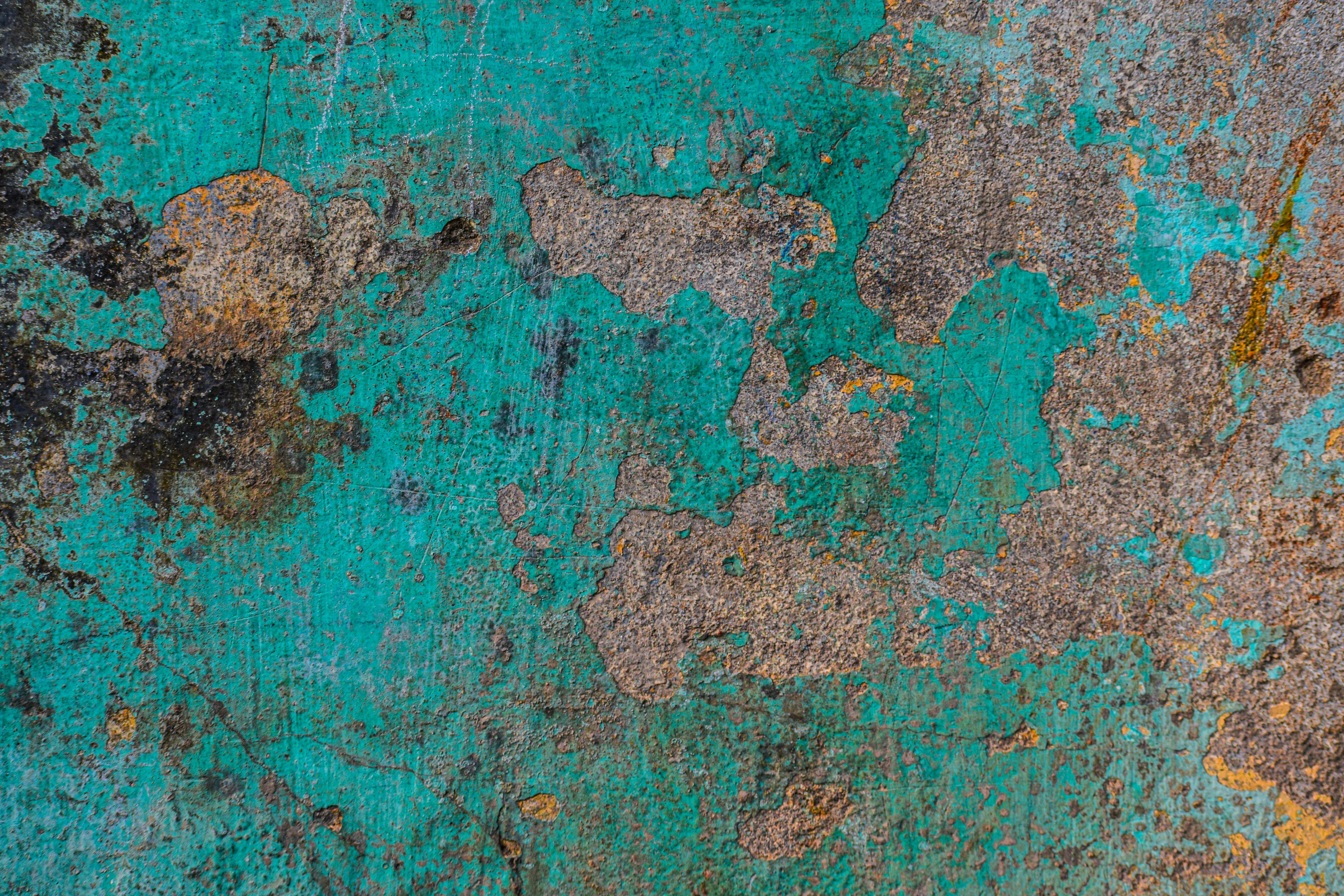 Free Close-up of a rustic, textured turquoise wall with peeling paint and patina details. Stock Photo