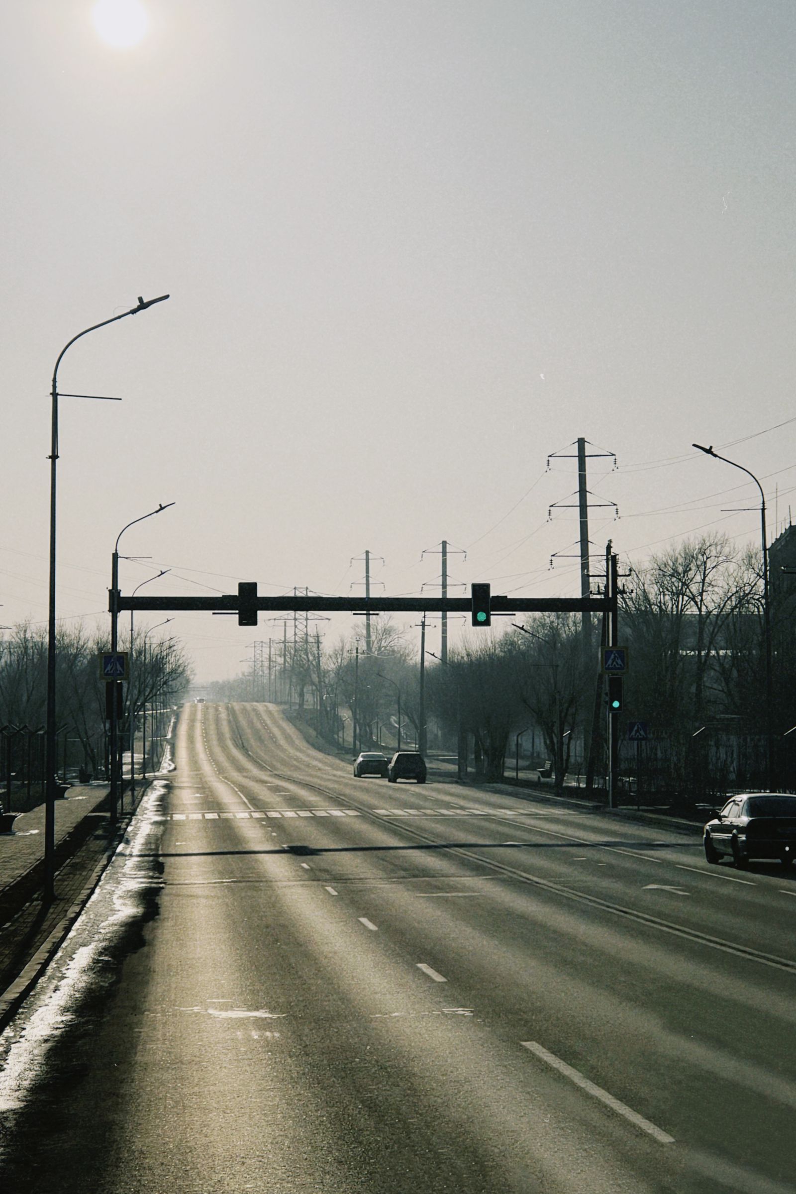 Empty road at dawn under a hazy sky