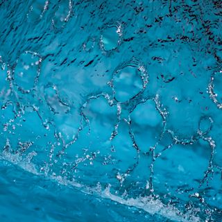 Abstract frozen water flow in deep teal — photo by Damir Mijailovic on Pexels