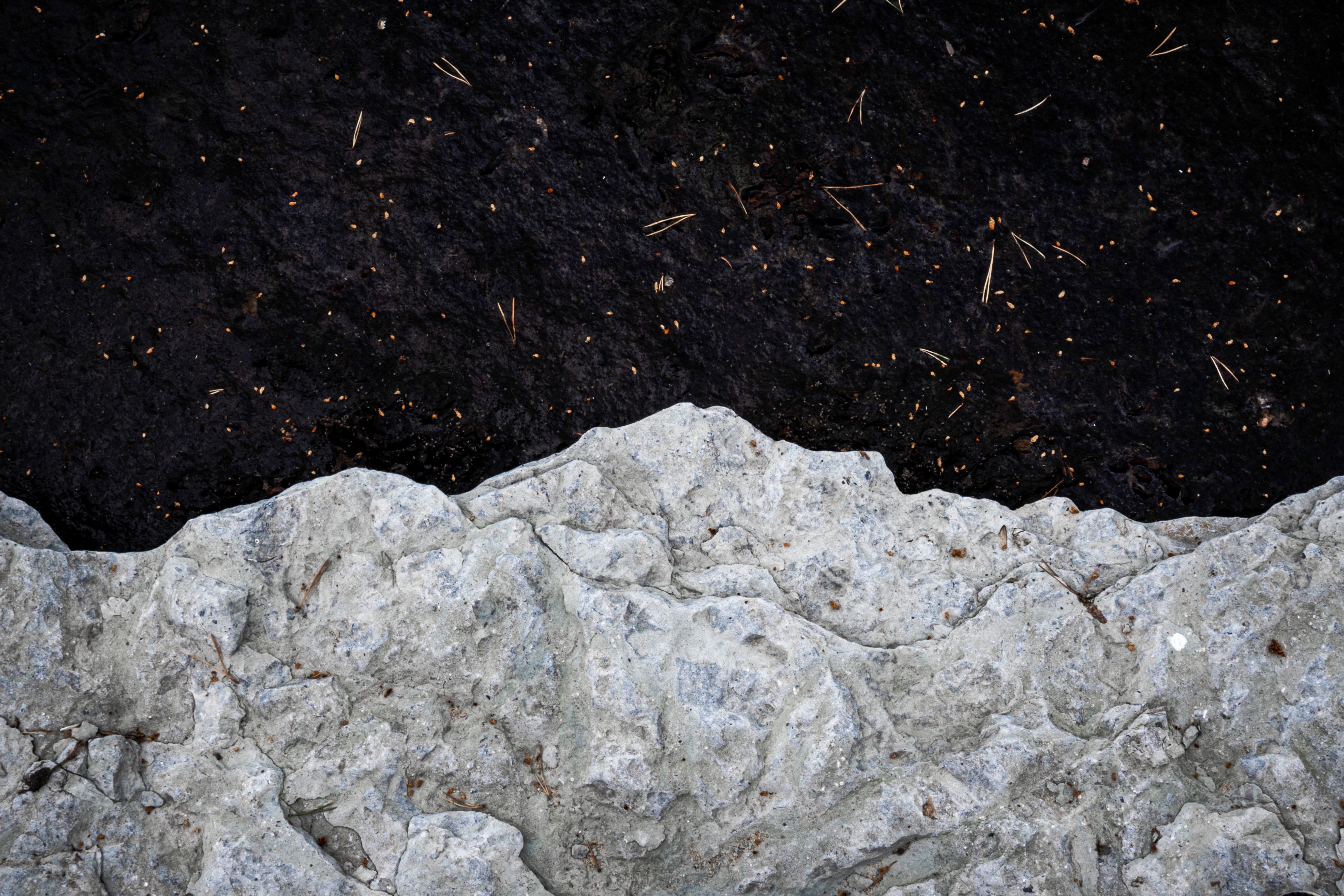 Textured Rock Formation and Dark Water Contrast · Free Stock Photo