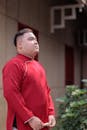 Man in Traditional Red Attire Outdoors
