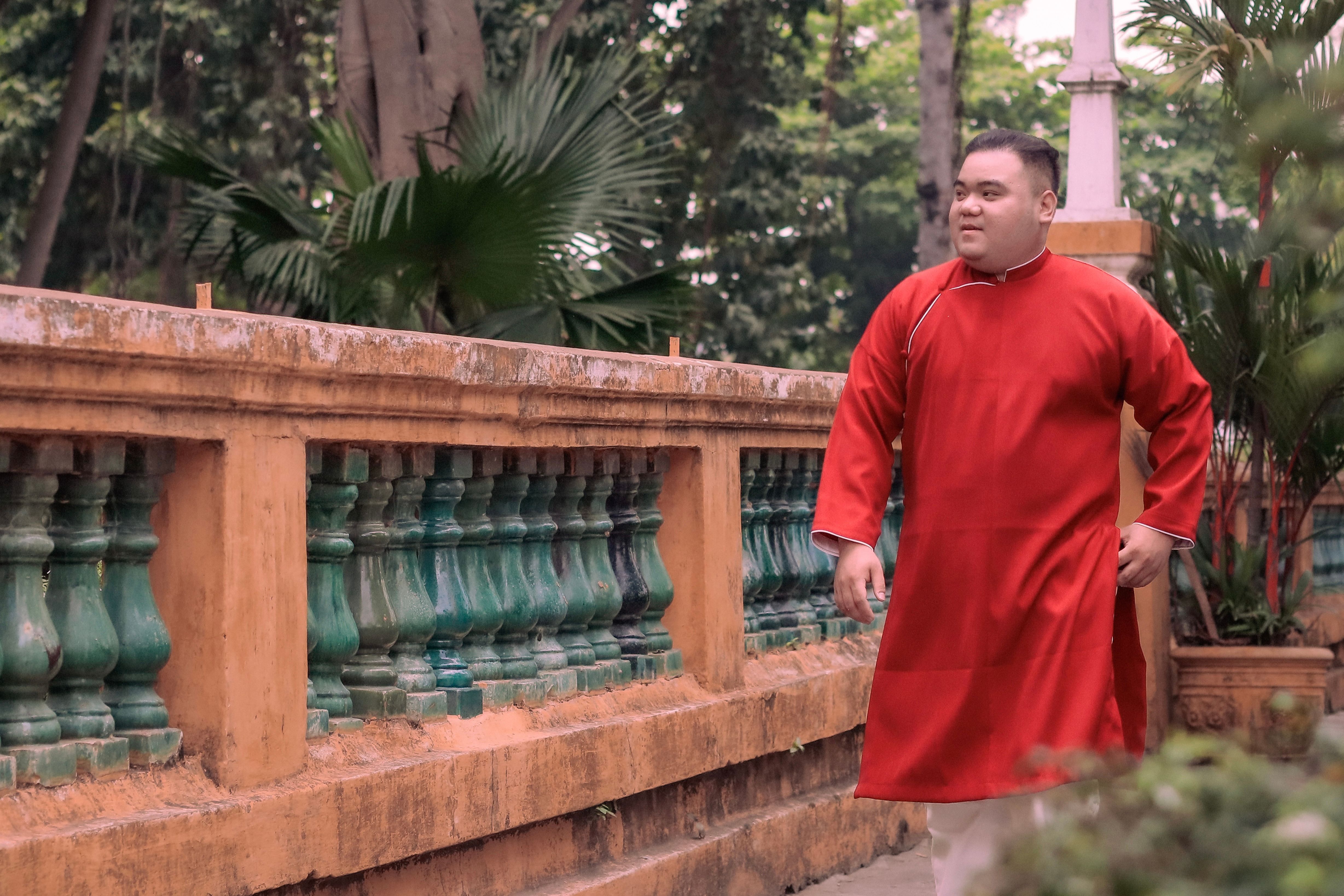 Man in Traditional Red Robe Outdoor Portrait · Free Stock Photo