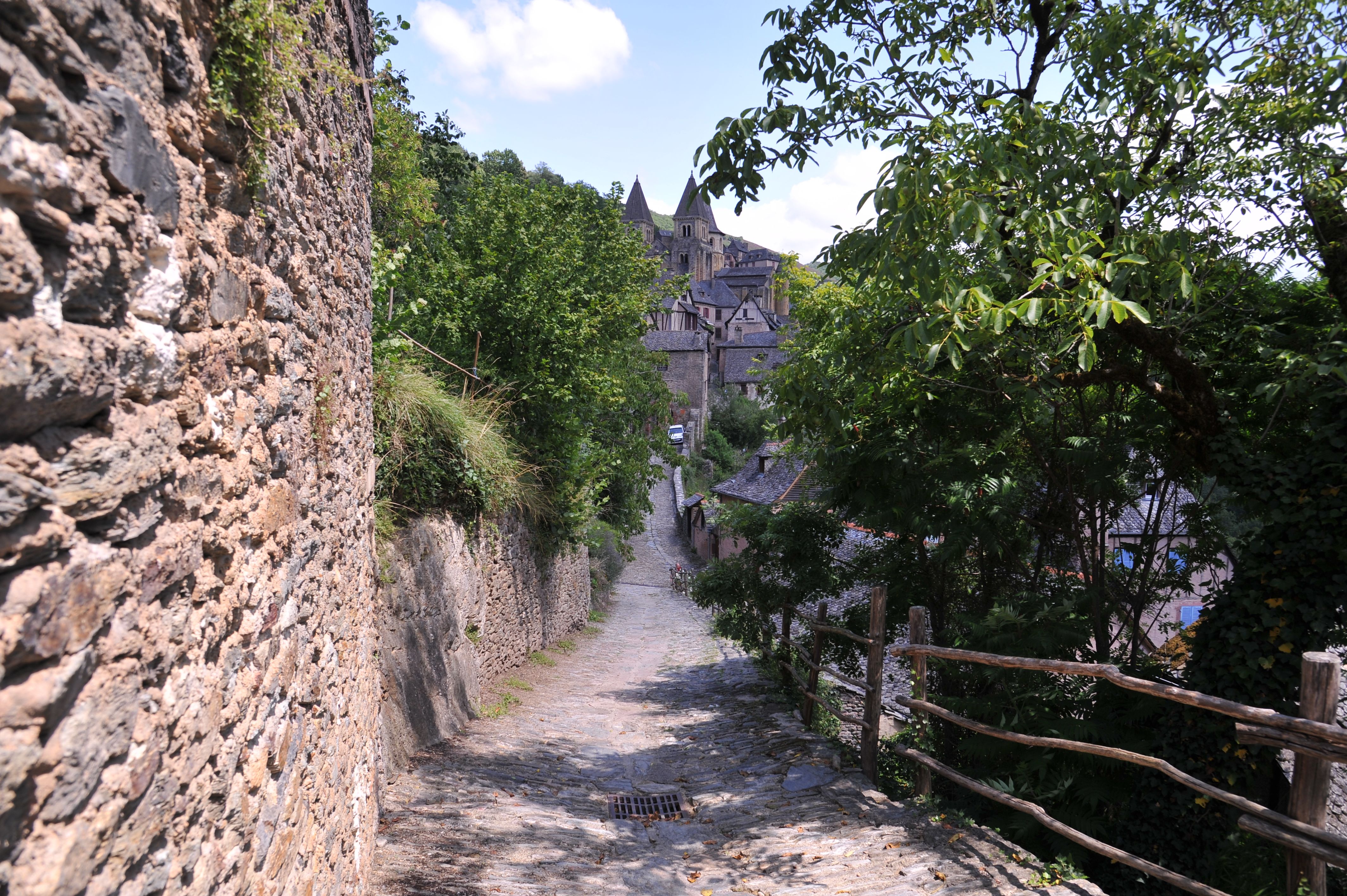 Sunlight on cobblestone street in a medieval walled village, Tuscany