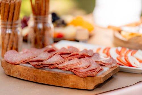 Sliced Meat On Brown Wooden Chopping Board
