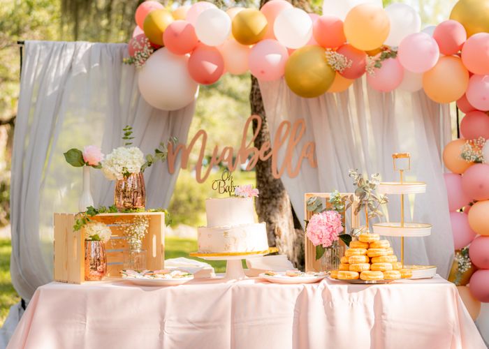 Garden baby shower table with cake and balloons