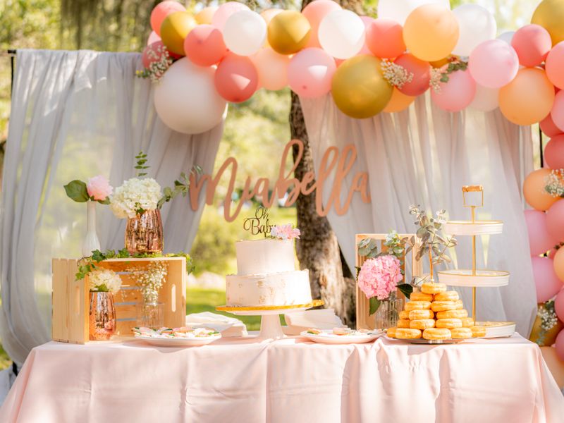 Garden baby shower table with cake and balloons