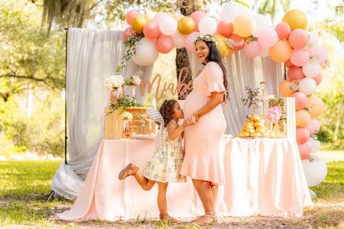 Free Girl Kissing Her Mother's Belly Stock Photo