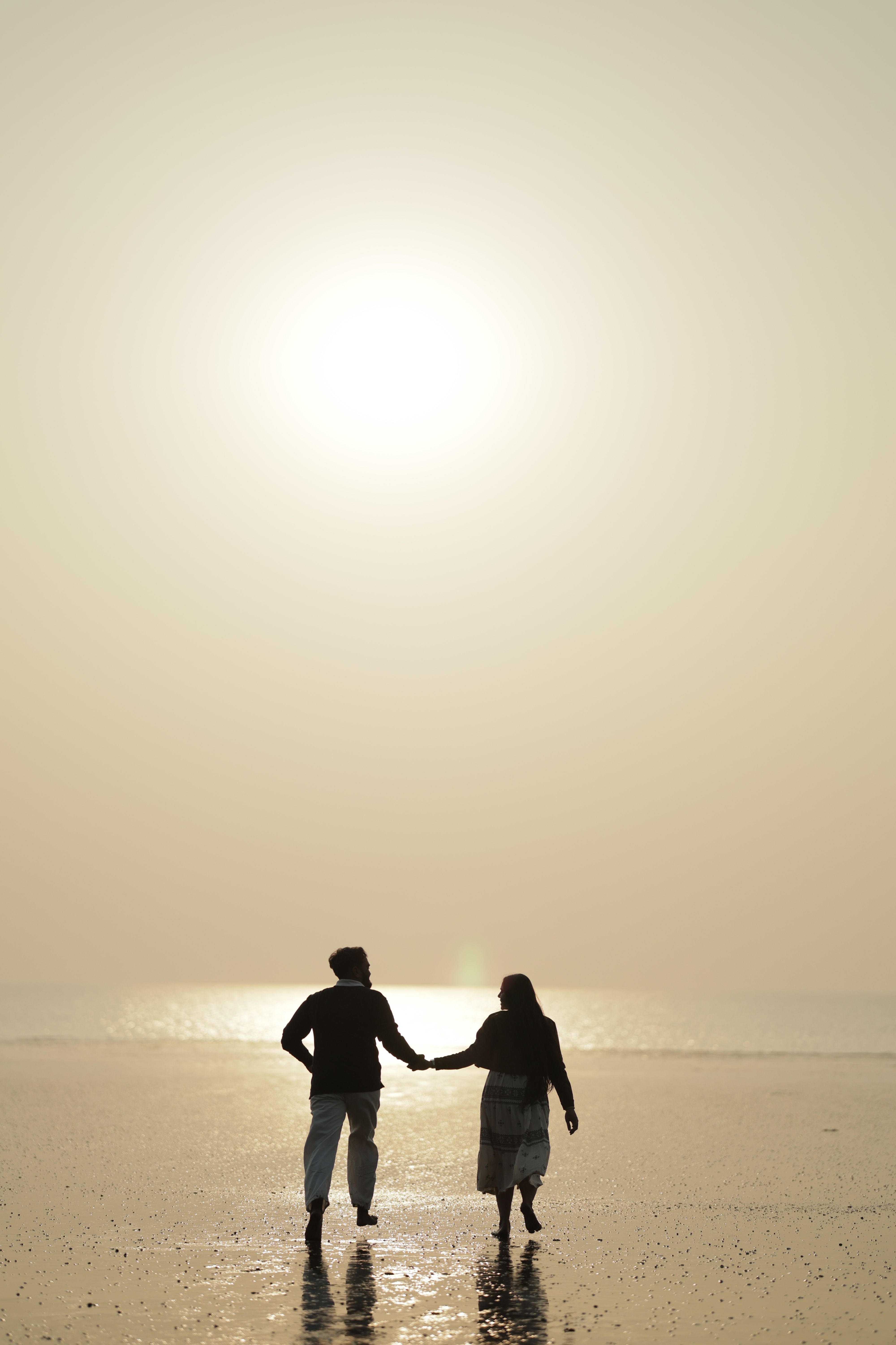 Silhouette of a Couple Walking on a Beach · Free Stock Photo