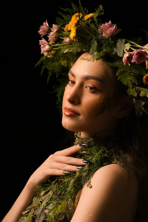 Free A captivating portrait of a woman adorned with a vibrant floral headdress, enhancing natural beauty. Stock Photo