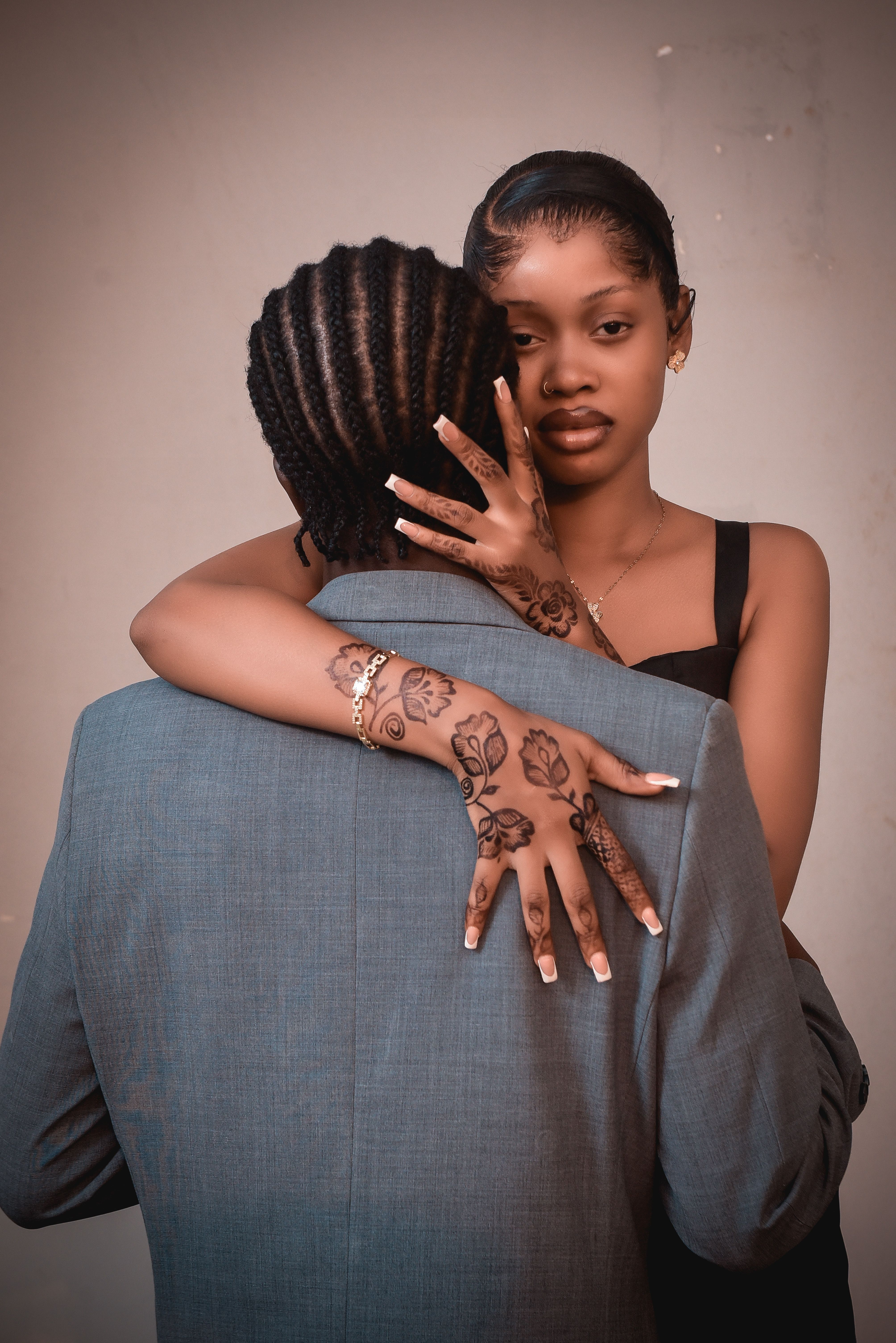 Elegant Couple Embracing with Hand Tattoos · Free Stock Photo
