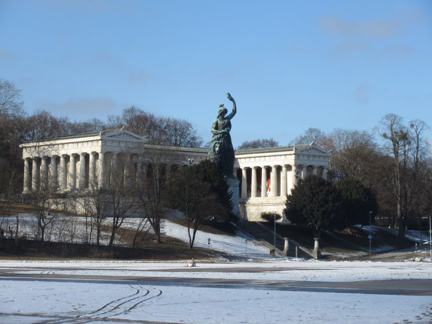 Bavaria statue with Hall of Fame in snowy Theresienwiese, Munich captured on a winter day.