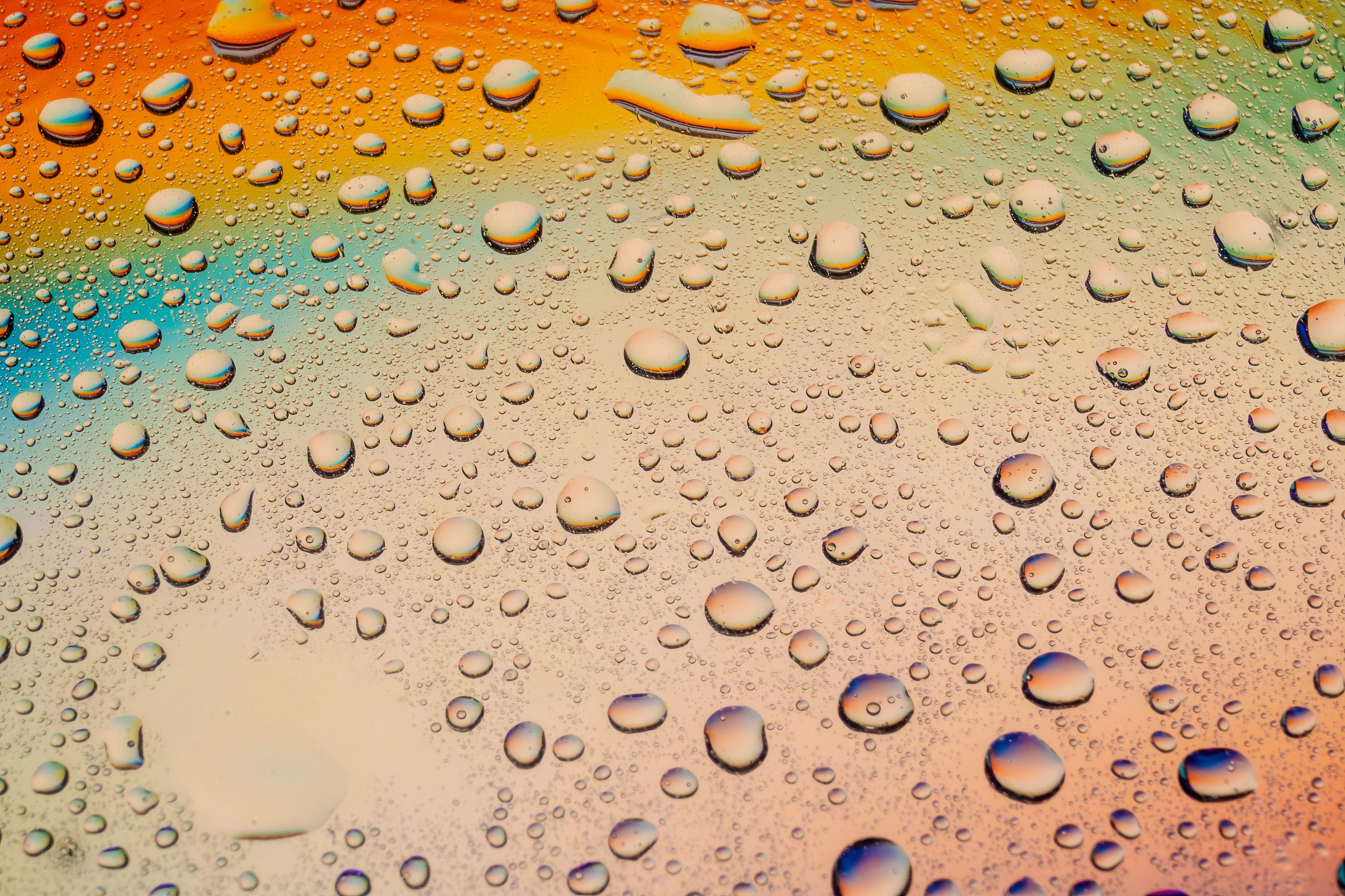 Vibrant Water Droplets on Rainbow Background · Free Stock Photo