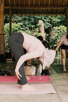 Group yoga class in a serene outdoor setting, focusing on relaxation and wellness.