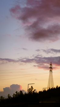 A scenic view of power lines against a vibrant dusk sky, capturing the tranquil essence of twilight.
