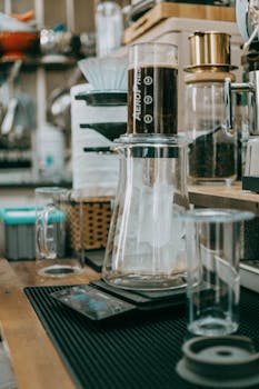 A stylish coffee brewing station featuring an AeroPress and various coffee gear in a cafe setting.
