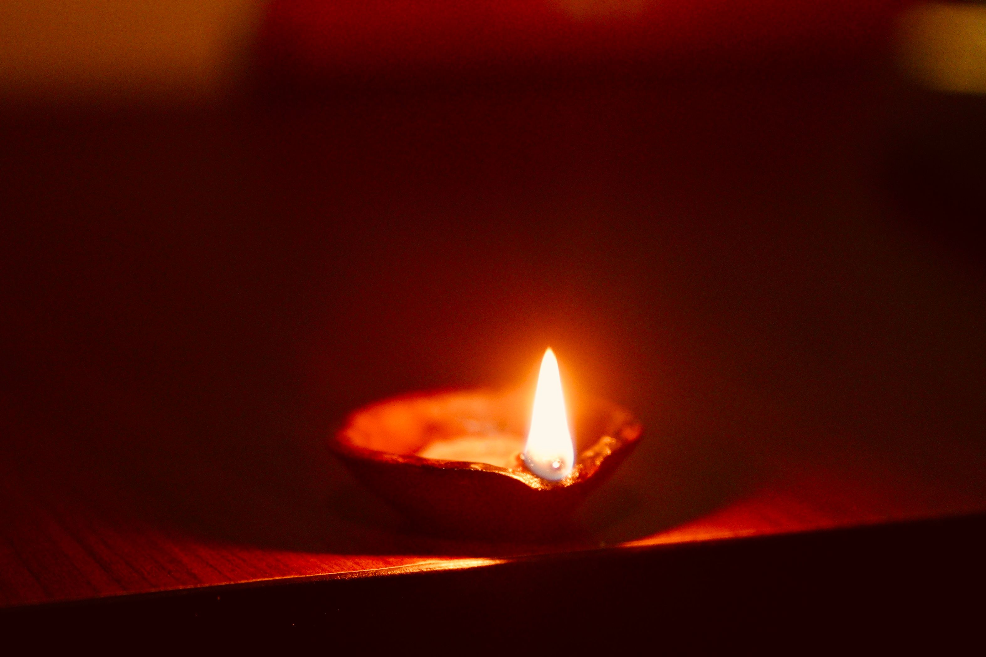 decoration of home in diwali A single oil lamp emits a warm glow, illuminating its surroundings with a soft, flickering light.