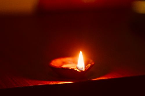 Free A single oil lamp emits a warm glow, illuminating its surroundings with a soft, flickering light. Stock Photo