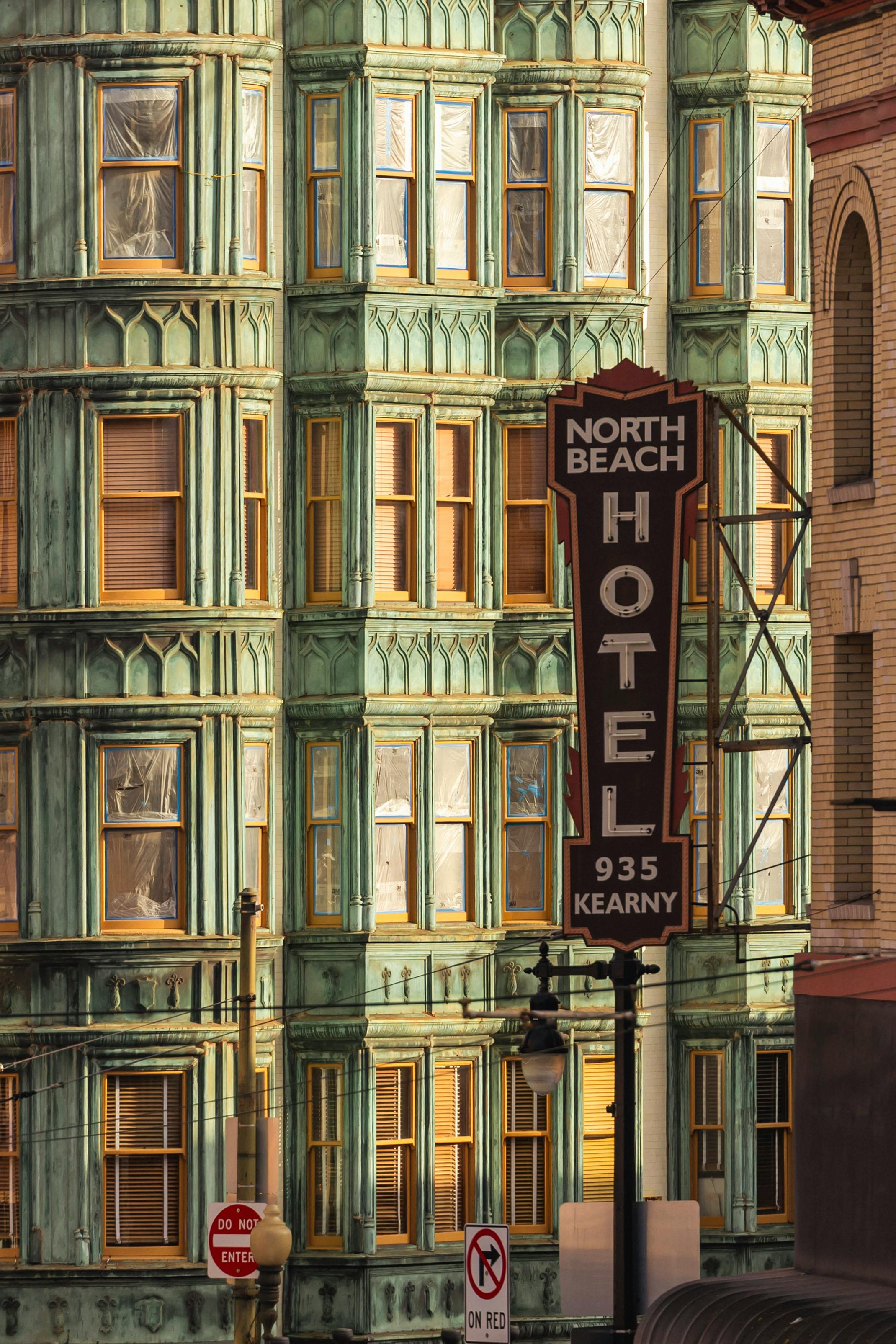 A view of the iconic North Beach Hotel in San Francisco with ornate architecture and vintage sign.