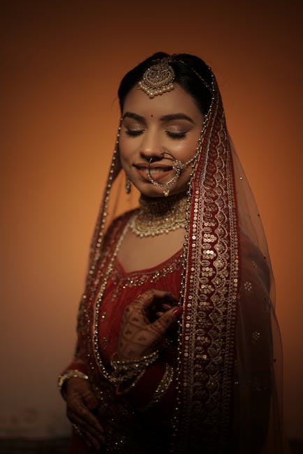 Beautiful Indian bride wearing traditional red bridal attire with intricate jewelry.