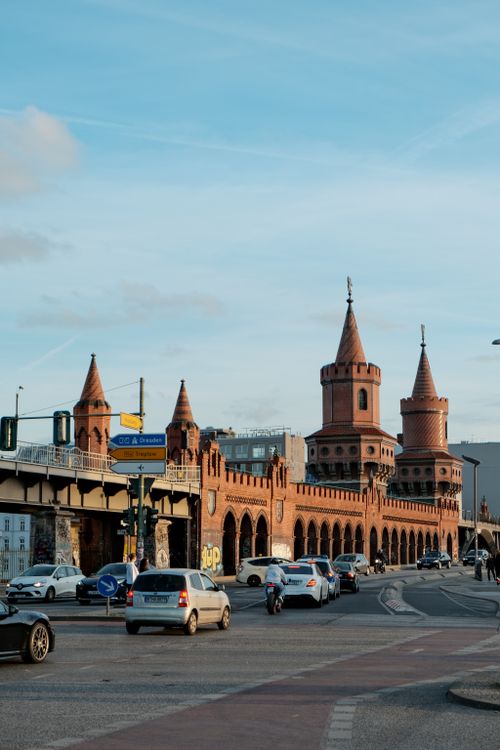 Free Oberbaum Bridge in Berlin with vehicles passing, set against a clear blue sky. Stock Photo