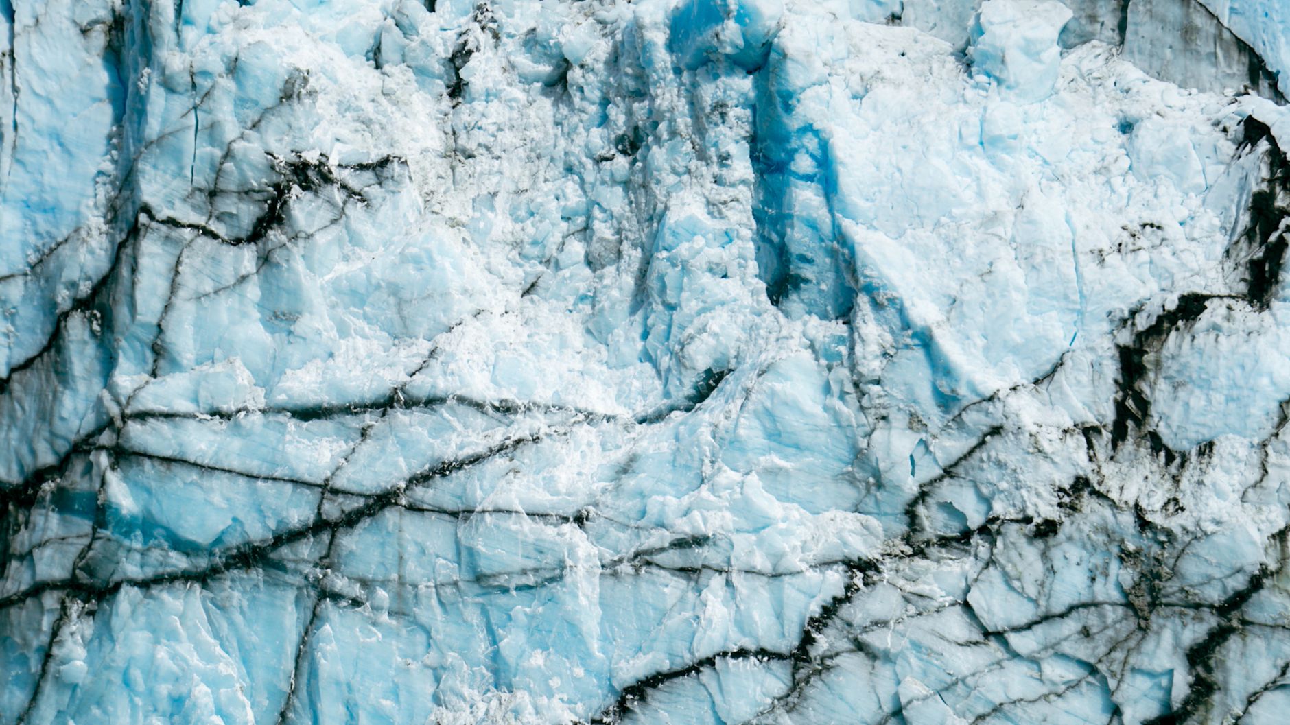 Detailed close-up of a glacier's textured ice surface with striking blue hues.. detailed, close, glaciers