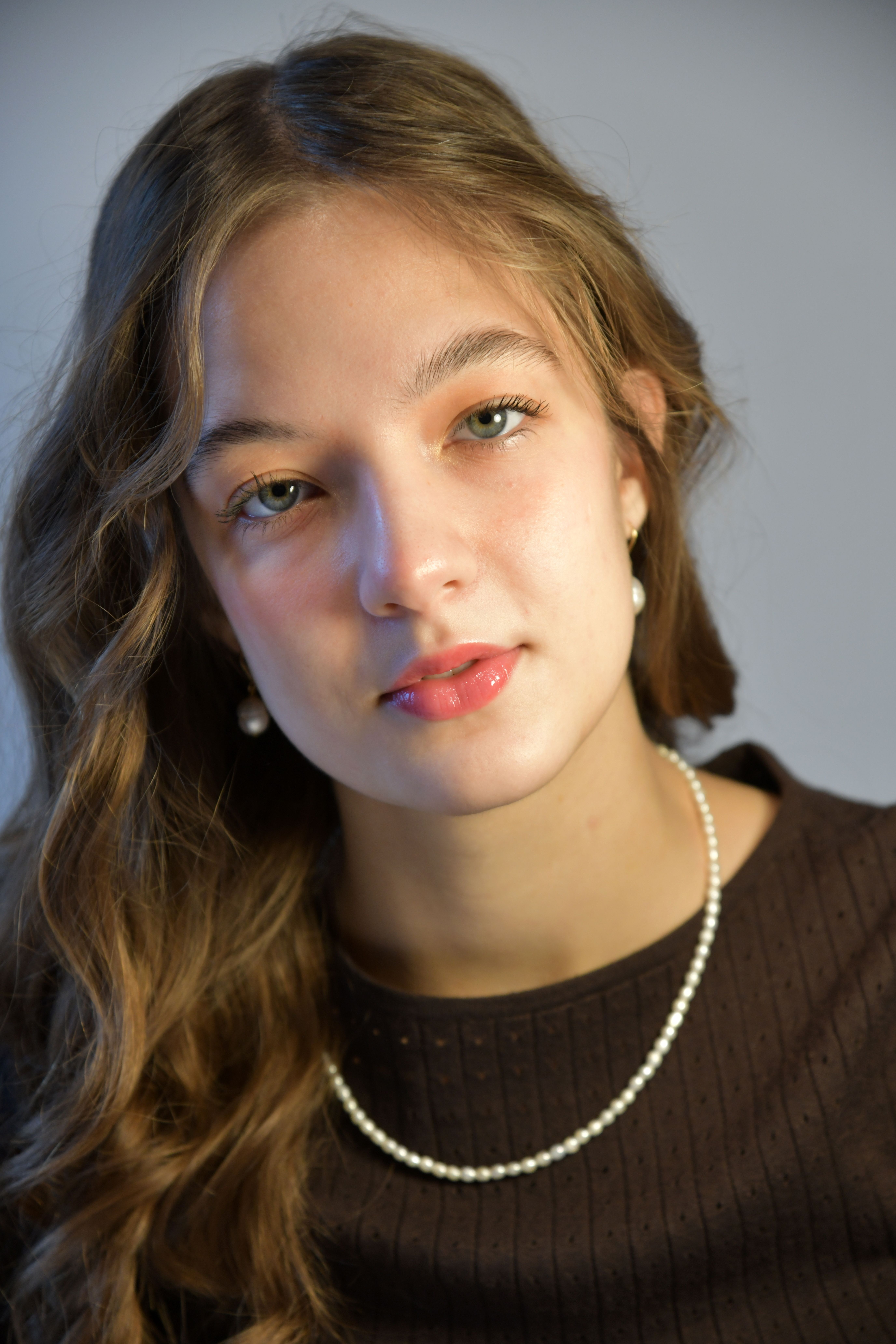 Elegant Portrait of a Young Woman with Pearls · Free Stock Photo