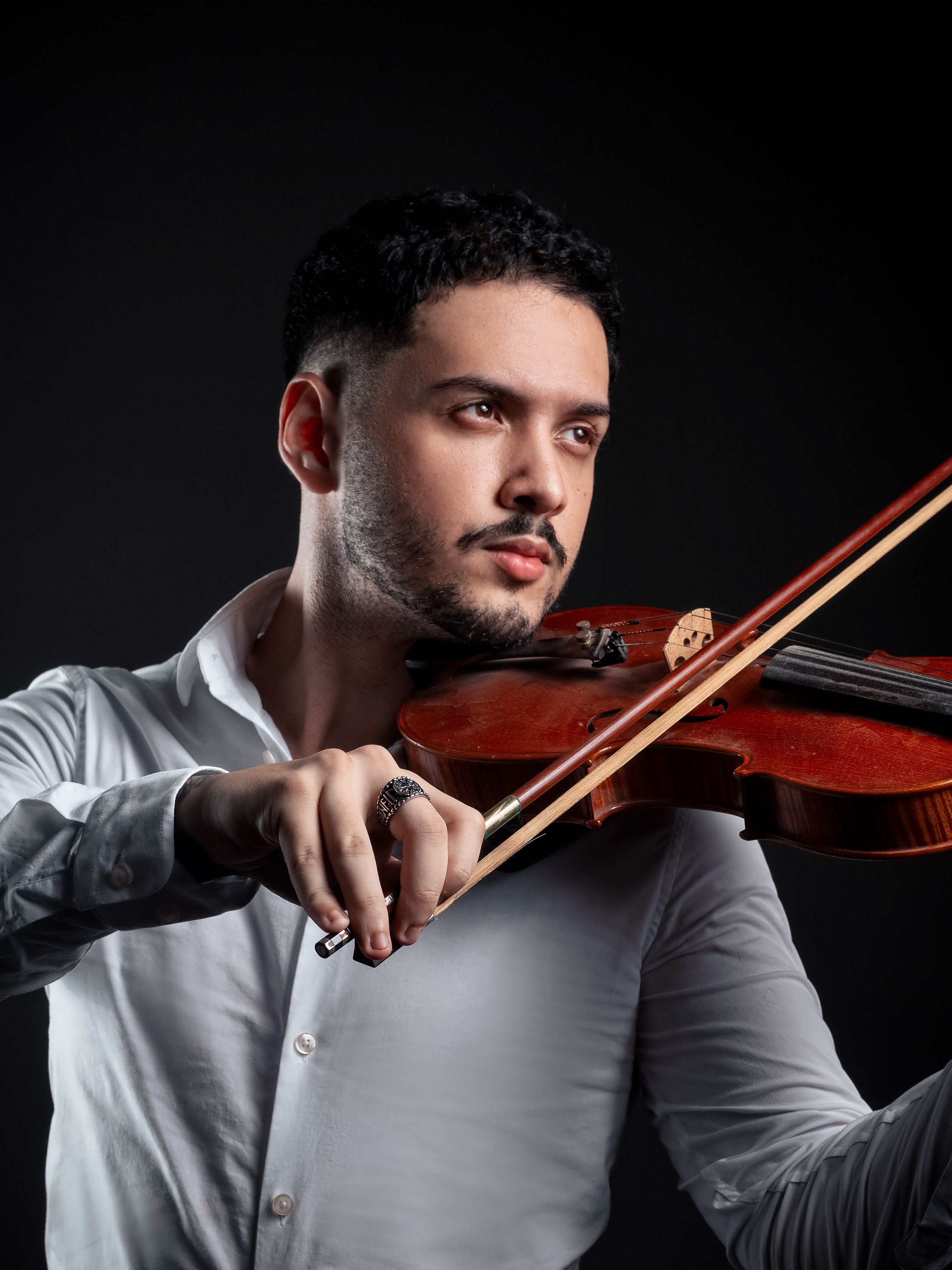 A detailed portrait of a man playing the violin, showcasing musical passion.