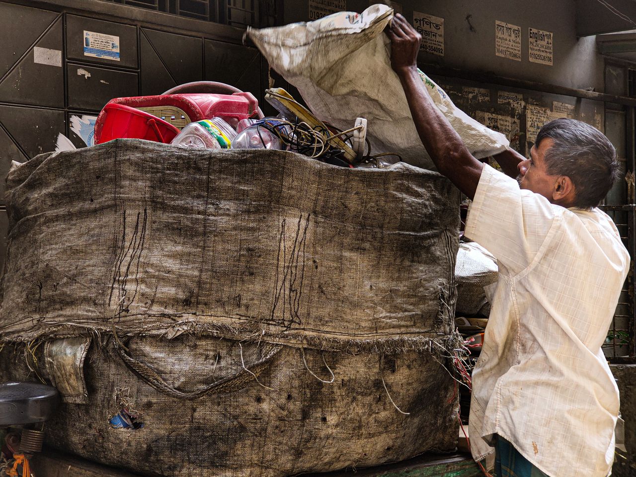A person sorts recyclable materials.