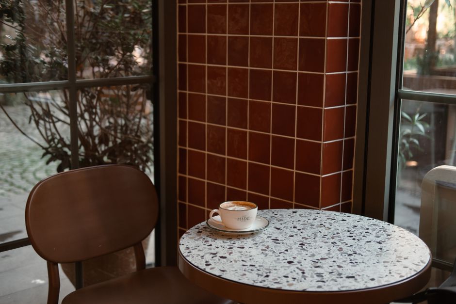 A warm, inviting café corner in Istanbul featuring a marble table and a cup of coffee.