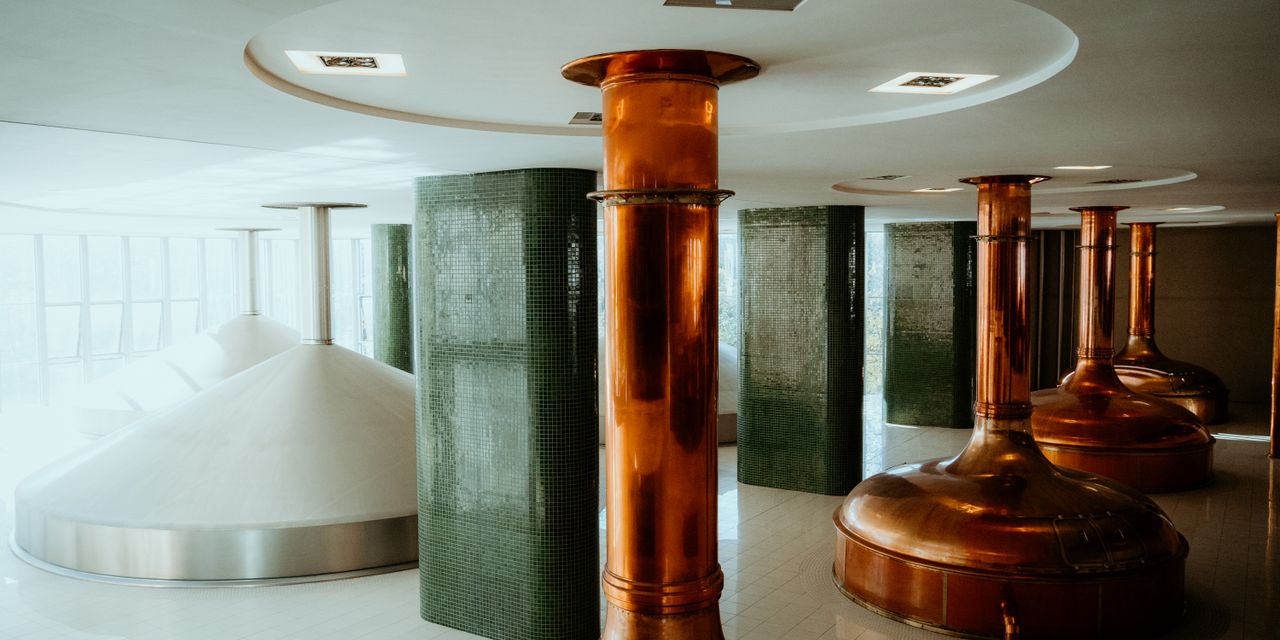 Interior view of a brewery in Pilsen, showcasing copper tanks and modern design.