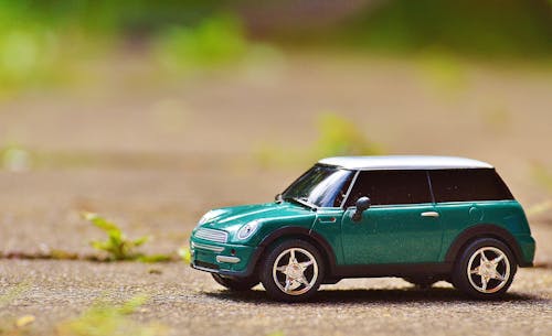 Free Green Scale Model Car on Brown Pavement Stock Photo