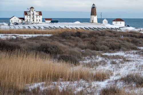 Free Explore the serene winter landscape of Point Judith Lighthouse in Narragansett, Rhode Island. Stock Photo